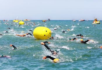 Pescara, Italy - June 9, 2013: athletes facing the swim split of the Ironman 70.3 Italy, 2013 cover the distance in the Adriatic Sea at Pescara. The competition saw 1500 partecipants from all over the world.